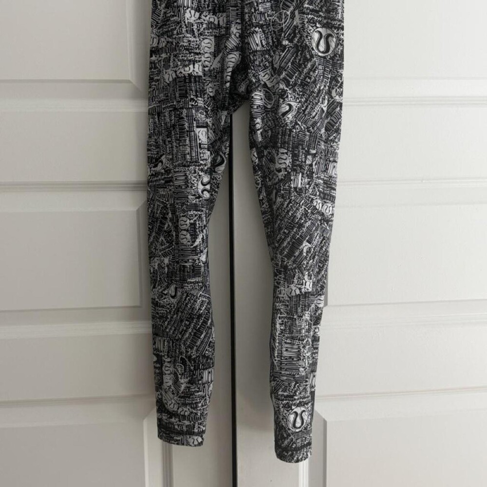 Lululemon black and white leggings with repeating text and logo pattern #activew